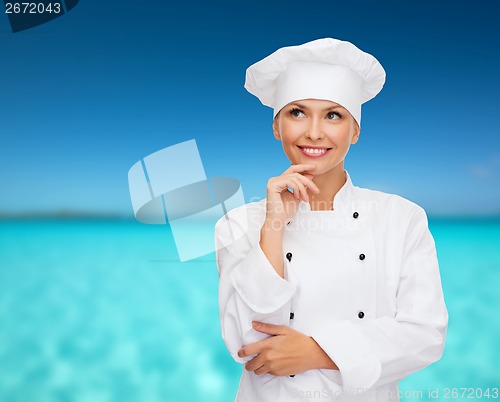 Image of smiling female chef dreaming