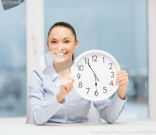 Image of attractive businesswoman with white clock