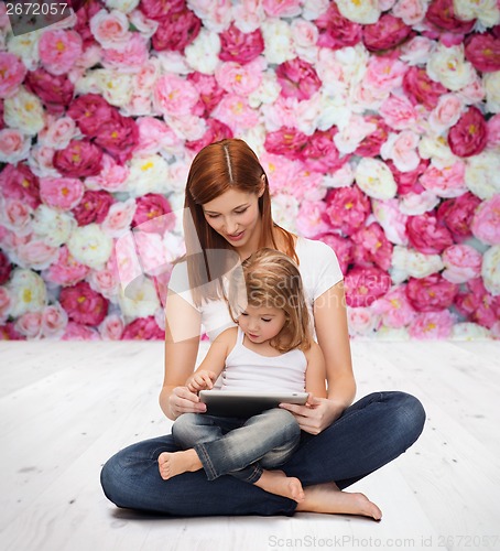 Image of happy mother with little girl and tablet pc