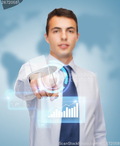 Image of buisnessman pointing finger to virtual screen