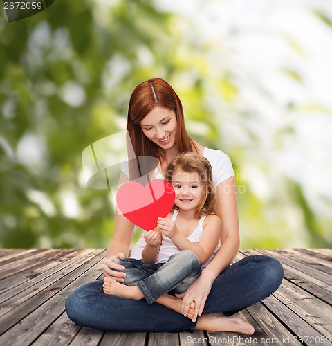 Image of happy mother with adorable little girl and heart