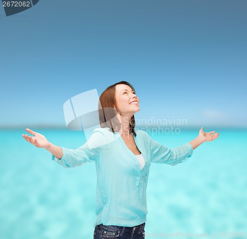 Image of smiling woman waving hands