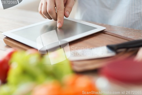 Image of closeup of man pointing finger to tablet pc