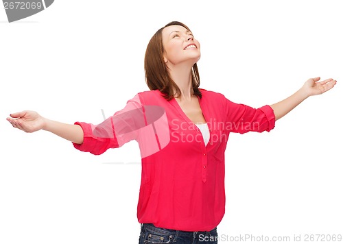 Image of smiling woman waving hands with closed eyes