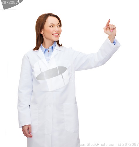 Image of doctor pointing to something or pressing button