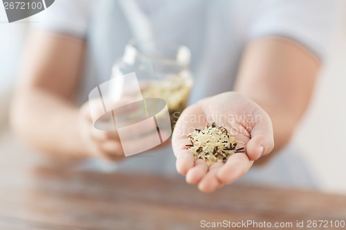 Image of male with white and wild black rice on palm