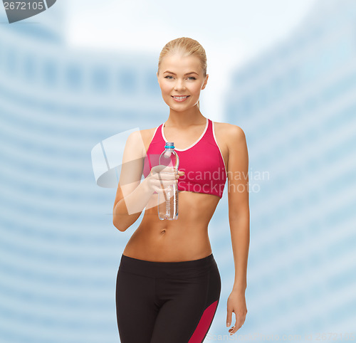 Image of smiling woman with bottle of water