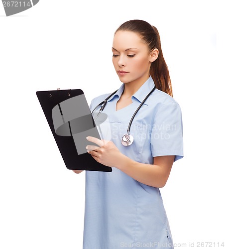 Image of serious female doctor or nurse with stethoscope