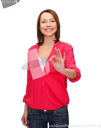 Image of woman in casual clothes showing ok gesture