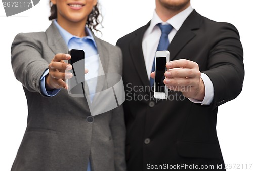 Image of businessman and businesswoman with smartphones