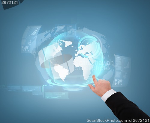 Image of close up of businessman pointing to globe hologram
