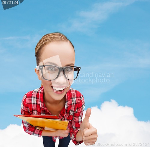 Image of student in glasses with folders showing thumbs up