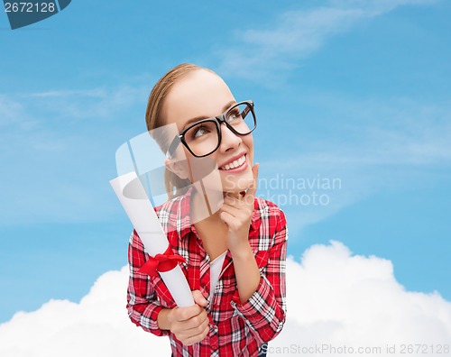 Image of smiling woman in black eyeglasses with diploma