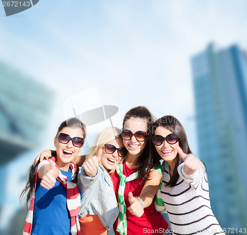 Image of teenage girls or young women showing thumbs up