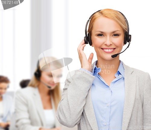 Image of friendly female helpline operator at office