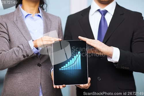 Image of businessman and businesswoman with tablet pc