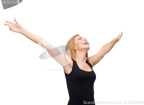 Image of smiling girl in blank black tank top waving hands