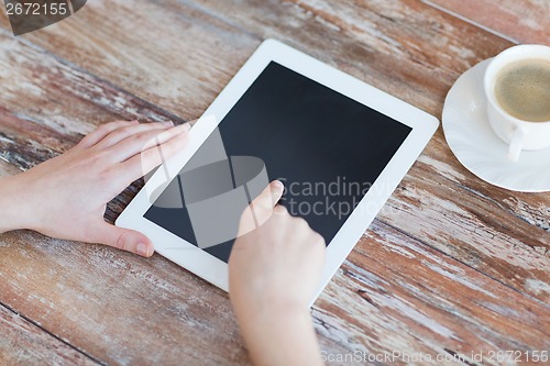 Image of female pointing finger to tablet pc screen