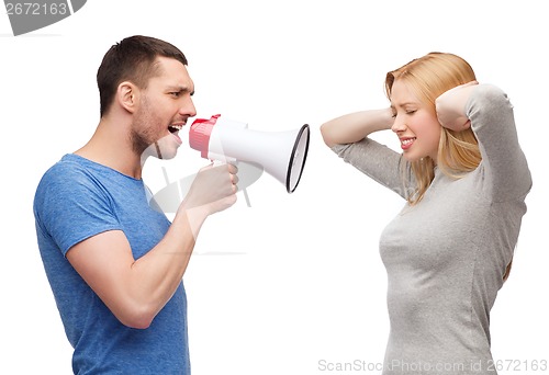 Image of boyfriend screaming though megaphone at girlfriend