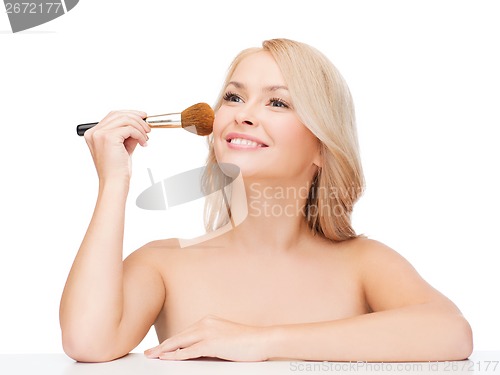 Image of beautiful woman with closed eyes and makeup brush