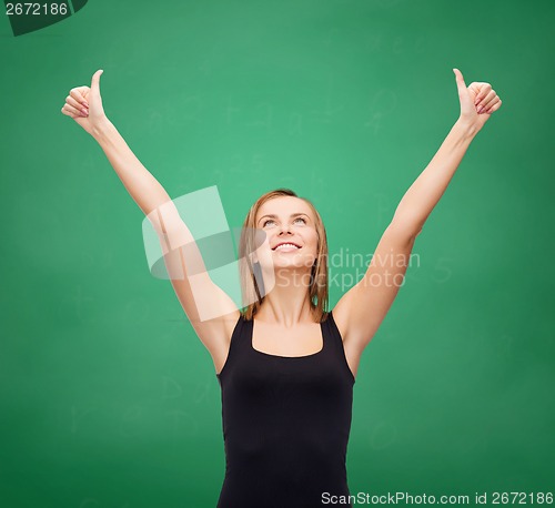 Image of woman in blank black tank top showing thumbs up