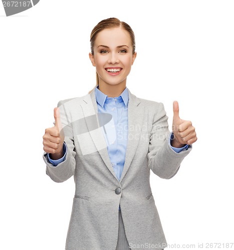 Image of smiling businesswoman showing thumbs up