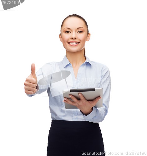Image of smiling woman looking at tablet pc computer