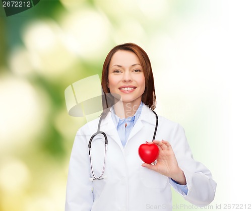 Image of smiling female doctor with heart and stethoscope