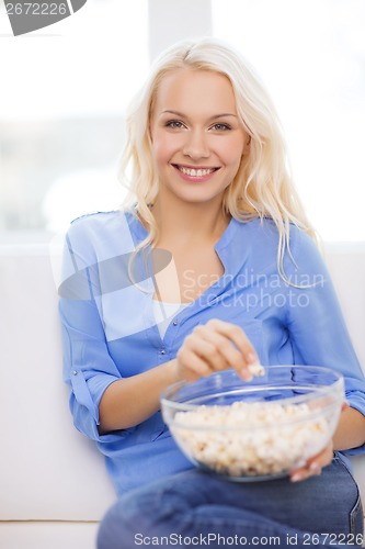 Image of young girl with popcorn ready to watch movie