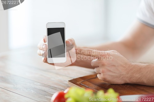 Image of close up of male hands holding smartphone