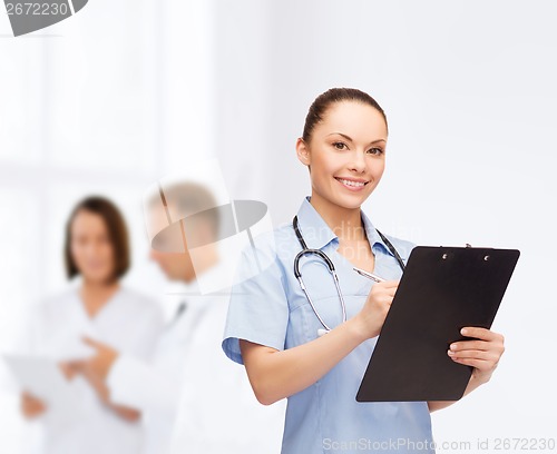 Image of smiling female doctor or nurse with stethoscope