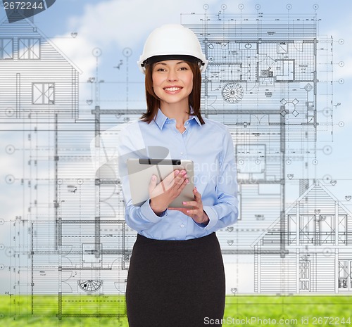 Image of young smiling businesswoman in white helmet