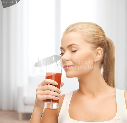 Image of young woman drinking tomato juice