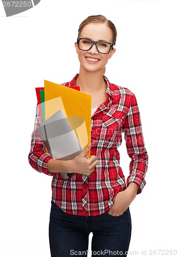 Image of female in eyeglasses with folders and tablet pc