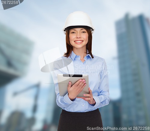Image of young smiling businesswoman in white helmet