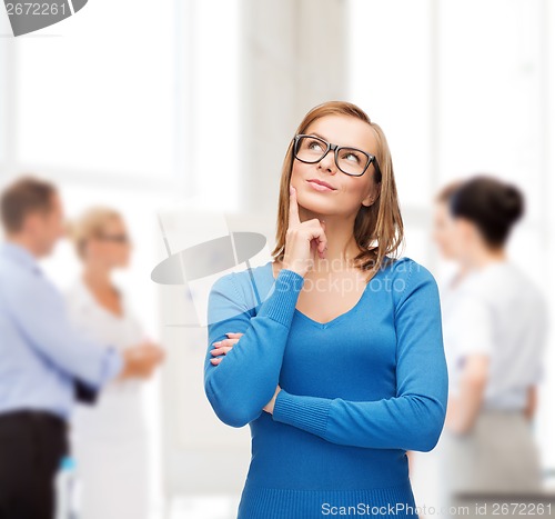 Image of happy woman in black eyeglasses dreaming