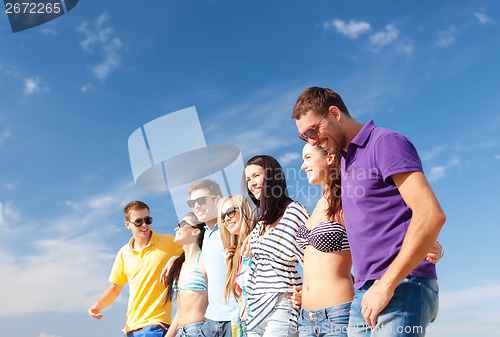 Image of group of friends having fun on the beach