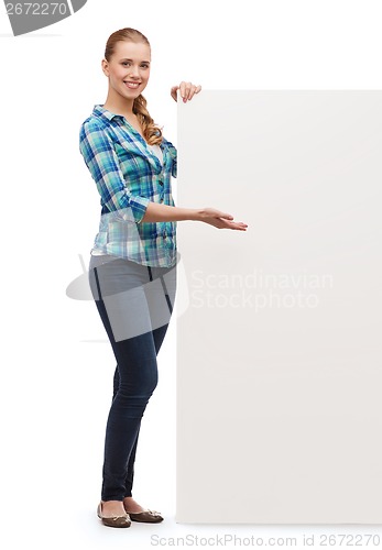 Image of smiling young woman with white blank board