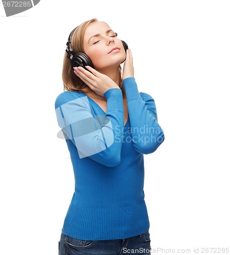 Image of calm young woman with headphones