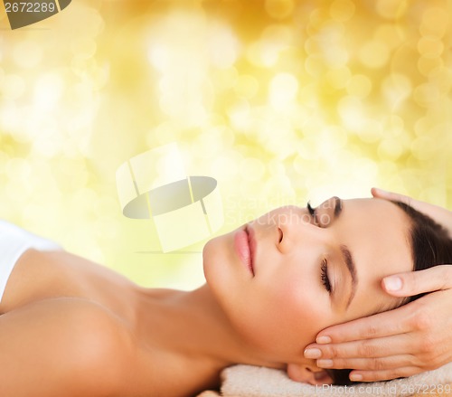 Image of beautiful woman in spa salon having facial