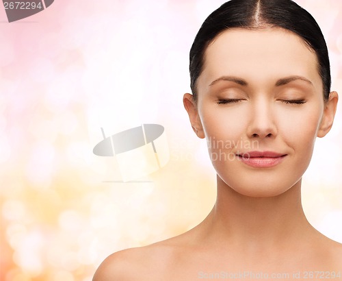 Image of young calm woman with closed eyes