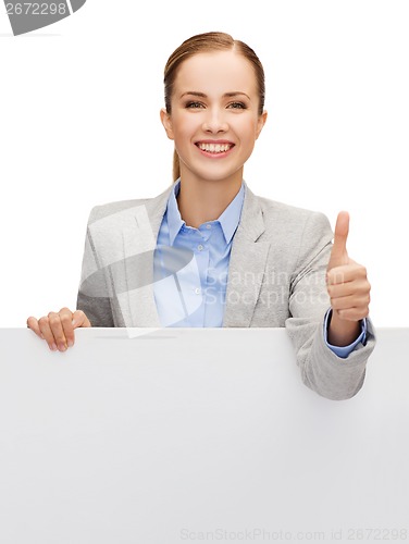 Image of smiling businesswoman with white blank board