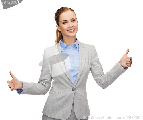 Image of smiling businesswoman showing thumbs up