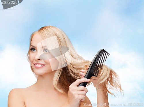 Image of smiling woman with hair brush