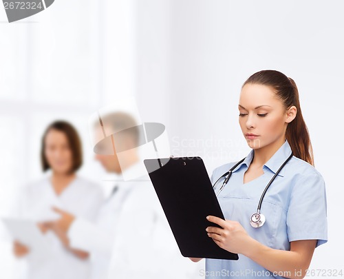 Image of serious female doctor or nurse with stethoscope