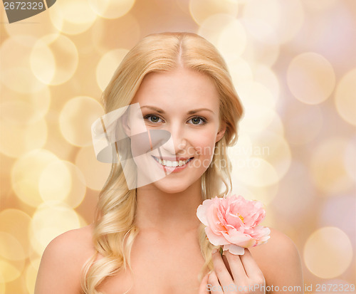 Image of smiling woman with peony flower