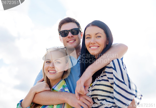 Image of group of friends having fun on the beach