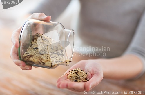 Image of female emptying jar with white and wild black rice