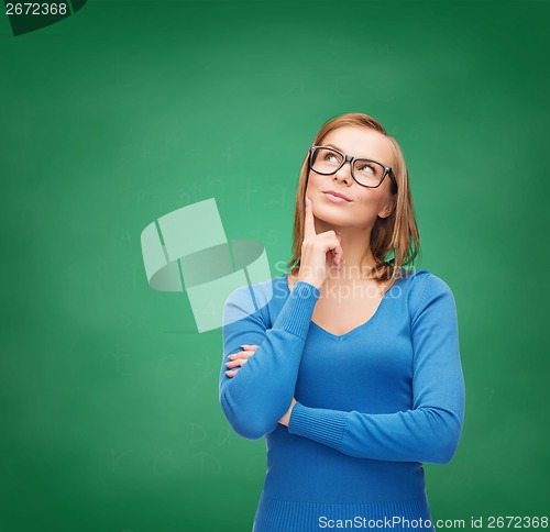 Image of happy woman in black eyeglasses dreaming