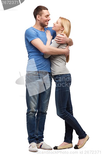 Image of smiling couple hugging and looking at each other